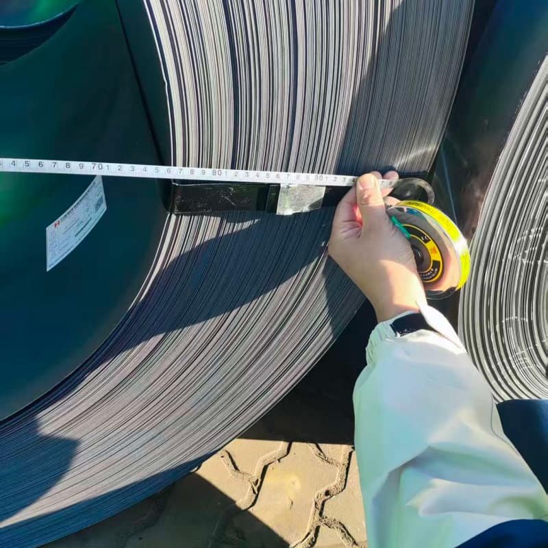 Side view of heavy gauge Hot Rolled Steel Coil showing thickness and mill edge,